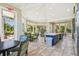 Brightly lit clubhouse with a kitchen island, multiple seating areas and a view of lush landscaping at 12408 Palatka Dr, Venice, FL 34293