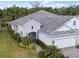 Gorgeous home showcasing meticulous landscaping, a paver driveway, and an attached two-car garage at 12408 Palatka Dr, Venice, FL 34293