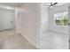 Hallway featuring a view into bedroom with a window and lots of natural light at 12408 Palatka Dr, Venice, FL 34293