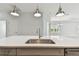 Close up of kitchen island with stainless steel sink, faucet and overhead pendant lighting at 12408 Palatka Dr, Venice, FL 34293