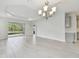 An open floorplan with a view to the kitchen and an outdoor patio at 12408 Palatka Dr, Venice, FL 34293