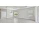 Bright living room with tile floors, large windows, and a decorative chandelier at 12408 Palatka Dr, Venice, FL 34293