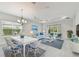 Bright living room features elegant decor, with a calming color palette and sliding glass doors to the yard at 12408 Palatka Dr, Venice, FL 34293