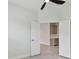 Living room with a ceiling fan and view of a kitchen through an opened door at 12408 Palatka Dr, Venice, FL 34293