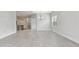 Bright, open-concept living space featuring gray tile flooring, neutral paint, and a modern chandelier at 12408 Palatka Dr, Venice, FL 34293