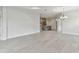 Bright living room with gray tile flooring, neutral walls, and modern fixtures at 12408 Palatka Dr, Venice, FL 34293