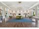 A spacious meeting room has several tables with comfortable chairs and large windows at 12408 Palatka Dr, Venice, FL 34293