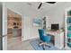 Bright office space adjacent to kitchen features desk, chair, and built in bookcase at 12408 Palatka Dr, Venice, FL 34293
