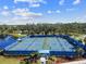 Aerial view of pickleball courts with players, set in a community with manicured landscaping and lake views at 12408 Palatka Dr, Venice, FL 34293