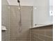 This walk-in shower has subway tile, rainfall shower head, and glass door at 12408 Palatka Dr, Venice, FL 34293
