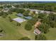 Aerial view of community park area with tennis courts, basketball court, and playground at 14198 Thoroughbred Dr, Dade City, FL 33525