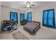 This bedroom features tile flooring, bright windows, and ceiling fan at 14198 Thoroughbred Dr, Dade City, FL 33525