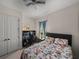 This bedroom features a desk with monitor, closet and ceiling fan at 14198 Thoroughbred Dr, Dade City, FL 33525