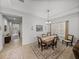 Cozy dining room with chandelier, window views, and adjacent hallway access at 14198 Thoroughbred Dr, Dade City, FL 33525
