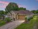 Inviting single-story home featuring a brick driveway, two-car garage and well-maintained landscaping at 14198 Thoroughbred Dr, Dade City, FL 33525