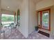 A welcoming front porch with a seating area and a front door with glass panels at 14198 Thoroughbred Dr, Dade City, FL 33525