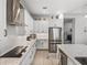 Well-lit kitchen featuring white cabinets, subway tile backsplash, granite countertops, and stainless steel appliances at 14198 Thoroughbred Dr, Dade City, FL 33525