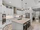 Modern kitchen with island seating, stainless appliances, and stylish pendant lighting at 14198 Thoroughbred Dr, Dade City, FL 33525