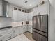 Updated kitchen with white cabinets, stainless steel appliances, granite countertops, and herring bone tile backsplash at 14198 Thoroughbred Dr, Dade City, FL 33525
