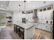 Bright eat-in kitchen featuring white cabinets, granite countertops, and stainless steel appliances at 14198 Thoroughbred Dr, Dade City, FL 33525