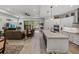 Open-concept living room and kitchen, complete with stainless steel appliances and a spacious island at 14198 Thoroughbred Dr, Dade City, FL 33525