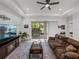 Bright living room features neutral tones, modern decor and a sliding door to the patio at 14198 Thoroughbred Dr, Dade City, FL 33525