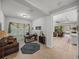 A spacious office featuring a brown leather couch, a brown desk and lots of natural light at 14198 Thoroughbred Dr, Dade City, FL 33525