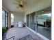 Spacious screened-in patio with brick flooring, ceiling fan and stainless steel grill, perfect for outdoor entertaining at 14198 Thoroughbred Dr, Dade City, FL 33525