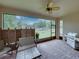 Covered patio with seating area and stainless steel grill at 14198 Thoroughbred Dr, Dade City, FL 33525