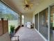 Spacious screened-in patio with brick flooring, ceiling fan and stainless steel grill, perfect for outdoor entertaining at 14198 Thoroughbred Dr, Dade City, FL 33525