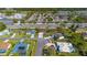 Aerial view of neighborhood with lush landscaping, sidewalks, and mature trees at 14296 Pullman Dr, Spring Hill, FL 34609