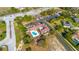 Aerial view of community center, highlighting the pool, clubhouse, playground, and parking area at 14296 Pullman Dr, Spring Hill, FL 34609
