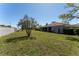Expansive backyard showcasing a lush lawn and partial view of the screened-in lanai at 14296 Pullman Dr, Spring Hill, FL 34609