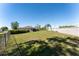 Expansive backyard featuring green grass, a privacy wall, and mature trees at 14296 Pullman Dr, Spring Hill, FL 34609