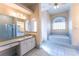 Bathroom with a soaking tub, large mirror, vanity and enclosed shower at 14296 Pullman Dr, Spring Hill, FL 34609