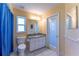Bright bathroom with a vanity, toilet, and a door leading to the exterior at 14296 Pullman Dr, Spring Hill, FL 34609
