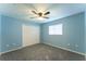 Relaxing blue bedroom with a ceiling fan, closet, and a window that brings in natural light at 14296 Pullman Dr, Spring Hill, FL 34609