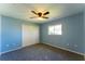 Relaxing blue bedroom with a ceiling fan, closet, and a window that brings in natural light at 14296 Pullman Dr, Spring Hill, FL 34609