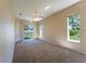 Large primary bedroom with carpeting, a ceiling fan, and sliding glass door at 14296 Pullman Dr, Spring Hill, FL 34609