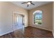 Inviting bedroom showcasing wood floors, ceiling fan, a large window, and ample natural light at 14296 Pullman Dr, Spring Hill, FL 34609