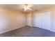 Inviting bedroom featuring neutral walls, carpet, a ceiling fan, closet and a door at 14296 Pullman Dr, Spring Hill, FL 34609