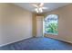 Cozy bedroom features neutral walls, carpet flooring, ceiling fan, and a bright window at 14296 Pullman Dr, Spring Hill, FL 34609