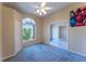 Bright bedroom with carpet flooring, ceiling fan, closet, and view of the outside at 14296 Pullman Dr, Spring Hill, FL 34609