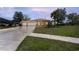 Charming single-story home featuring a three-car garage and well-manicured lawn at 14296 Pullman Dr, Spring Hill, FL 34609