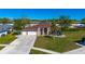 Charming single-story home featuring a three-car garage and well-manicured lawn at 14296 Pullman Dr, Spring Hill, FL 34609
