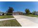 Charming single-story home featuring a three-car garage and well-manicured lawn at 14296 Pullman Dr, Spring Hill, FL 34609
