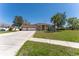 Charming single-story home featuring a three-car garage and well-manicured lawn at 14296 Pullman Dr, Spring Hill, FL 34609