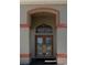 Detailed view of the front door with decorative glass inserts and modern hardware at 14296 Pullman Dr, Spring Hill, FL 34609