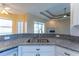 Open kitchen with granite breakfast bar overlooking the living area at 14296 Pullman Dr, Spring Hill, FL 34609