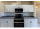Close up of stainless steel appliances surrounded by white cabinets and granite countertops at 14296 Pullman Dr, Spring Hill, FL 34609